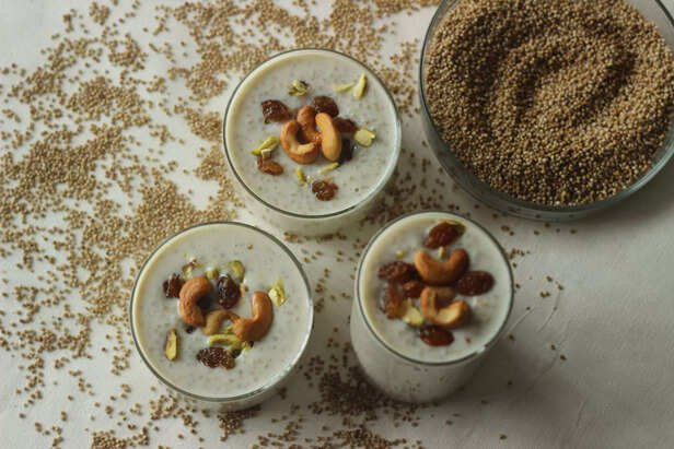 Kodo millet pudding. Rich creamy and sweet dessert garnished with ghee roasted raisins and nuts. An indian pudding made with roasted kodo millet and milk.