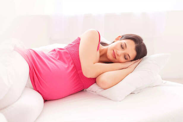 Cute pregnant woman is having a nap
